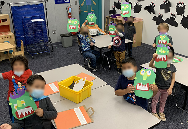 Students showing off their Halloween Monster crafts